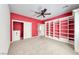 Spacious carpeted bedroom with fan, recessed lighting, built-in shelving, and plenty of storage space at 2154 Idaho Falls Dr, Henderson, NV 89044
