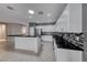 Kitchen with white cabinets, stainless steel appliances, and a black countertop island at 2154 Idaho Falls Dr, Henderson, NV 89044
