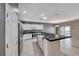 Modern kitchen featuring stainless steel appliances, white cabinetry, a black countertop, and outdoor access at 2154 Idaho Falls Dr, Henderson, NV 89044