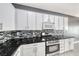 Close up of kitchen featuring stainless steel appliances, granite countertop and decorative tile backsplash at 2154 Idaho Falls Dr, Henderson, NV 89044