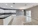 Bright kitchen featuring white cabinets, black countertops, and sliding door access to outdoor space at 2154 Idaho Falls Dr, Henderson, NV 89044