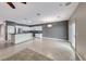 Bright, open-concept living space with tile floors, white kitchen cabinets and modern appliances at 2154 Idaho Falls Dr, Henderson, NV 89044