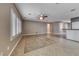 Neutral toned living area featuring tile flooring, a ceiling fan and shuttered windows bringing in natural light at 2154 Idaho Falls Dr, Henderson, NV 89044