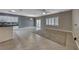 Bright living space with a tile floor, a sliding glass door to the backyard, and a partial view of the kitchen at 2154 Idaho Falls Dr, Henderson, NV 89044