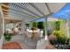 Inviting covered patio with a dining area and seating, surrounded by beautiful landscaping and plenty of natural light at 2154 Idaho Falls Dr, Henderson, NV 89044