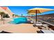 Resort-style pool with lounge chairs and umbrellas, perfect for relaxation and recreation at 2154 Idaho Falls Dr, Henderson, NV 89044