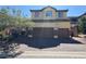 Charming two-story home features a two-car garage and desert landscaping, enhancing curb appeal at 252 Quail Ranch Dr, Henderson, NV 89015
