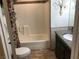 Bathroom featuring tiled floors, bath tub, granite counter vanity, and decorative wall art at 308 Sunbeam Dr, Las Vegas, NV 89107