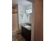 Bathroom featuring a tiled shower, dark granite vanity, and neutral-toned tile flooring at 308 Sunbeam Dr, Las Vegas, NV 89107