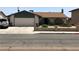 Charming single-story home featuring a two-car garage and a quaint front yard, perfect for curb appeal at 308 Sunbeam Dr, Las Vegas, NV 89107