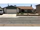 Charming single-story home featuring an attached garage, well-maintained landscaping, and a welcoming front porch at 308 Sunbeam Dr, Las Vegas, NV 89107