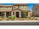 Charming two-story home with a stone facade, covered porch, and manicured landscaping at 3240 Avernus Ave, Henderson, NV 89044