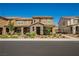 Charming two-story townhome featuring stone accents, a covered porch, and well-maintained landscaping at 3240 Avernus Ave, Henderson, NV 89044