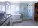 Bathroom boasts a soaking tub and glass-enclosed shower, with a granite-topped vanity at 3412 Adventure Ct, Las Vegas, NV 89129