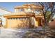 Inviting tan two-story home featuring a two-car garage and covered front porch at 3412 Adventure Ct, Las Vegas, NV 89129