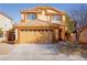 Charming tan two-story home featuring a two-car garage and well-maintained landscaping at 3412 Adventure Ct, Las Vegas, NV 89129
