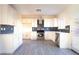 Bright kitchen features white cabinets, stainless steel appliances, and sleek backsplash at 3412 Adventure Ct, Las Vegas, NV 89129