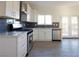 Modern kitchen with stainless steel appliances, white cabinets, and a window over the sink at 3412 Adventure Ct, Las Vegas, NV 89129