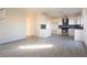 Spacious living room with white walls and wood flooring, leading into the modern kitchen at 3412 Adventure Ct, Las Vegas, NV 89129