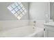 Bright bathtub with a glass block window and a modern faucet in neutral colored bath at 3538 Canter Dr, North Las Vegas, NV 89032