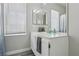 Bright bathroom features a vanity with ample storage, decorative plants, and a framed mirror at 3538 Canter Dr, North Las Vegas, NV 89032