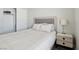 Bedroom featuring a gray headboard, wood-look floors, closet, and a night stand with a crystal lamp at 3538 Canter Dr, North Las Vegas, NV 89032