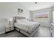 Primary bedroom featuring a large bed, side tables, and a large window at 3538 Canter Dr, North Las Vegas, NV 89032