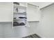 Walk-in closet with modern shelving, hanging rods, and folded and hanging clothes at 3538 Canter Dr, North Las Vegas, NV 89032