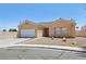 Charming front exterior with stucco facade, tiled roof, low maintenance desert landscaping, and attached two-car garage at 3538 Canter Dr, North Las Vegas, NV 89032