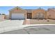 Inviting single-story home with neutral stucco, tiled roof, desert landscaping, and a convenient two-car garage at 3538 Canter Dr, North Las Vegas, NV 89032