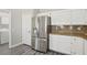 The kitchen features a stainless steel refrigerator and white cabinetry at 3538 Canter Dr, North Las Vegas, NV 89032