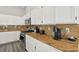 Kitchen counter features granite counters, appliances and white cabinetry at 3538 Canter Dr, North Las Vegas, NV 89032