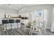 Bright eat-in kitchen boasts white cabinetry, granite counters, and stainless steel appliances at 3538 Canter Dr, North Las Vegas, NV 89032