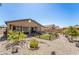 Landscaped backyard offers covered patio, fenced lawn area, and rock ground cover at 357 S Milan St, Henderson, NV 89015