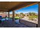 Covered patio leading to a meticulously landscaped backyard with a turf area at 357 S Milan St, Henderson, NV 89015