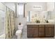 Bathroom with granite countertops, and sinks, a shower, and decorative window at 357 S Milan St, Henderson, NV 89015