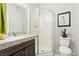 Bathroom featuring granite countertops, glass enclosed shower, and a decorative mirror at 357 S Milan St, Henderson, NV 89015