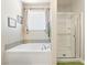 Bathroom featuring a large tub, shower, and natural light at 357 S Milan St, Henderson, NV 89015