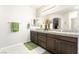 Double sink bathroom with neutral walls, granite countertop, and green towels at 357 S Milan St, Henderson, NV 89015