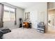 Spare bedroom with a large window, mirror, and comfortable carpet at 357 S Milan St, Henderson, NV 89015