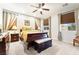 Comfortable bedroom with a ceiling fan, large windows, and neutral decor at 357 S Milan St, Henderson, NV 89015