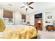Relaxing bedroom with a queen-size bed, natural light, and a TV at 357 S Milan St, Henderson, NV 89015