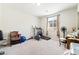 Versatile spare bedroom with an exercise bike, weights, and comfortable carpet at 357 S Milan St, Henderson, NV 89015