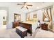 Bright bedroom featuring a queen-sized bed, soft lighting, and carpet flooring at 357 S Milan St, Henderson, NV 89015