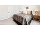 Cozy bedroom featuring neutral walls, carpet flooring, and a comfortable bed with decorative bedside lamps at 357 S Milan St, Henderson, NV 89015
