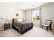 Cozy bedroom with natural lighting, neutral tones, and carpet flooring at 357 S Milan St, Henderson, NV 89015