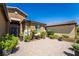 Charming courtyard with desert landscaping, brick pavers, and wrought-iron gate at 357 S Milan St, Henderson, NV 89015