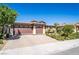 Attractive home with a 3-car garage, brick driveway, and well-maintained front yard at 357 S Milan St, Henderson, NV 89015