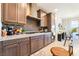 Elegant kitchen featuring granite countertops, stainless steel appliances, and dark wood cabinets at 357 S Milan St, Henderson, NV 89015
