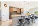 Open kitchen with a granite island, pendant lighting, and stainless steel appliances at 357 S Milan St, Henderson, NV 89015